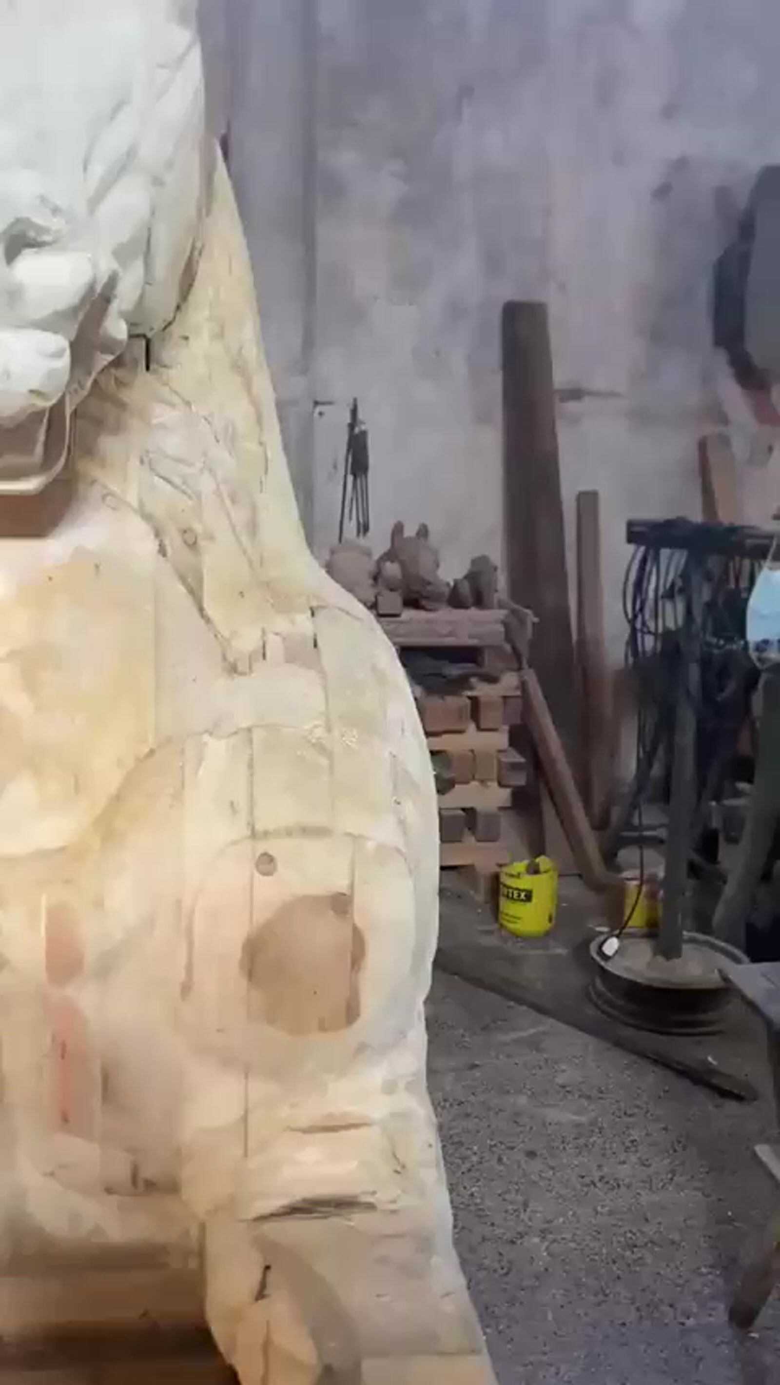 a man working on a statue of a lion