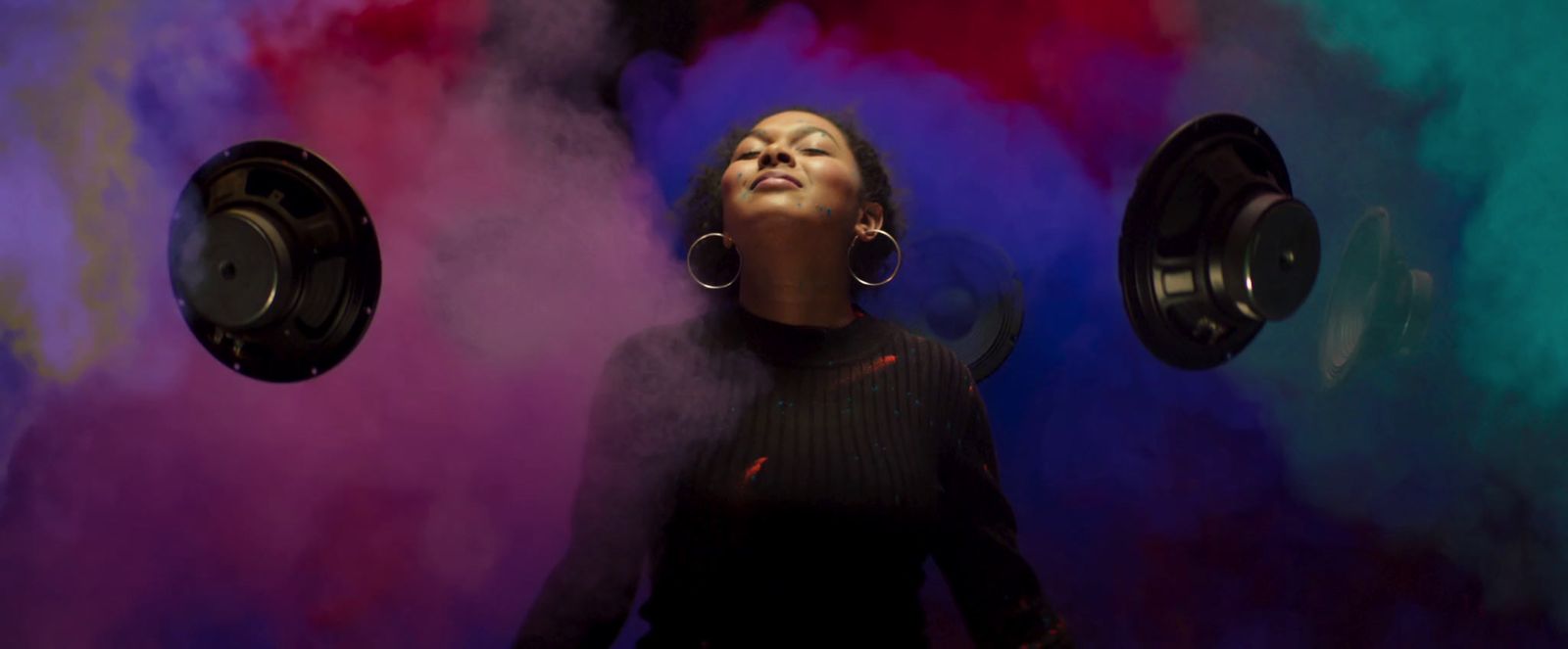 a woman standing in front of a colorful background