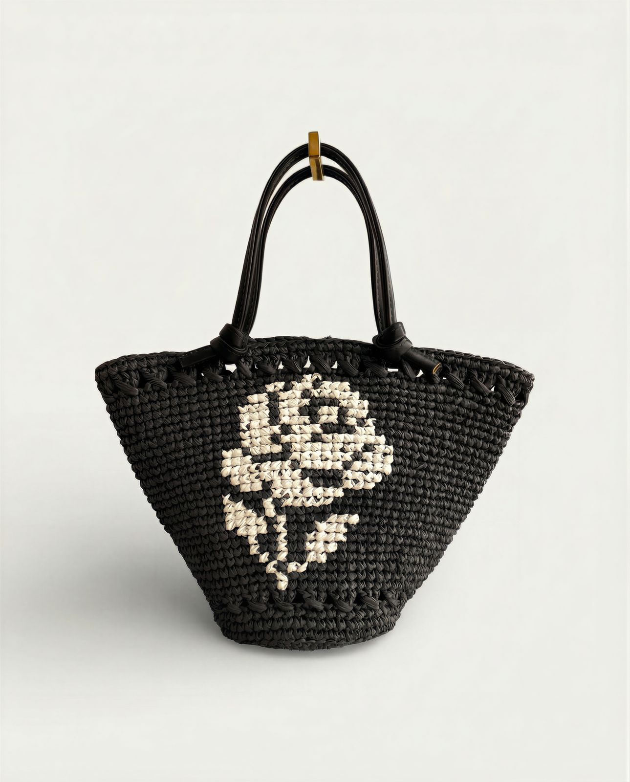 a black and white handbag with a skull on it