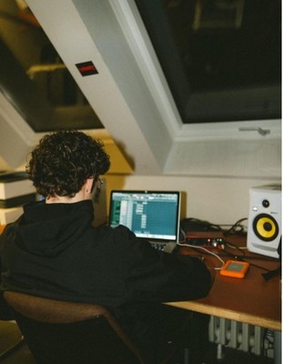 a person sitting at a desk with a computer