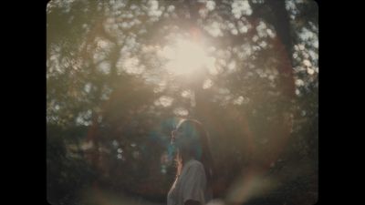 a woman standing in the middle of a forest
