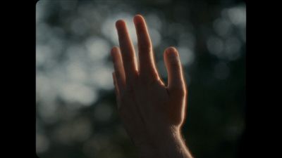 a person's hand reaching up into the air
