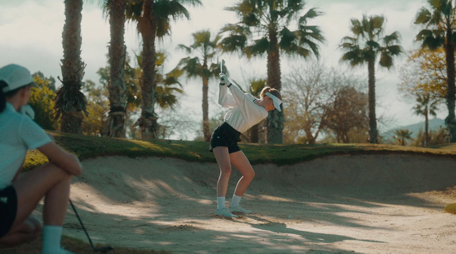 a woman swinging a tennis racquet on a tennis court