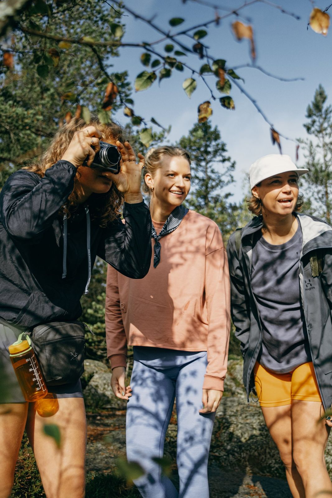 a group of three people standing next to each other