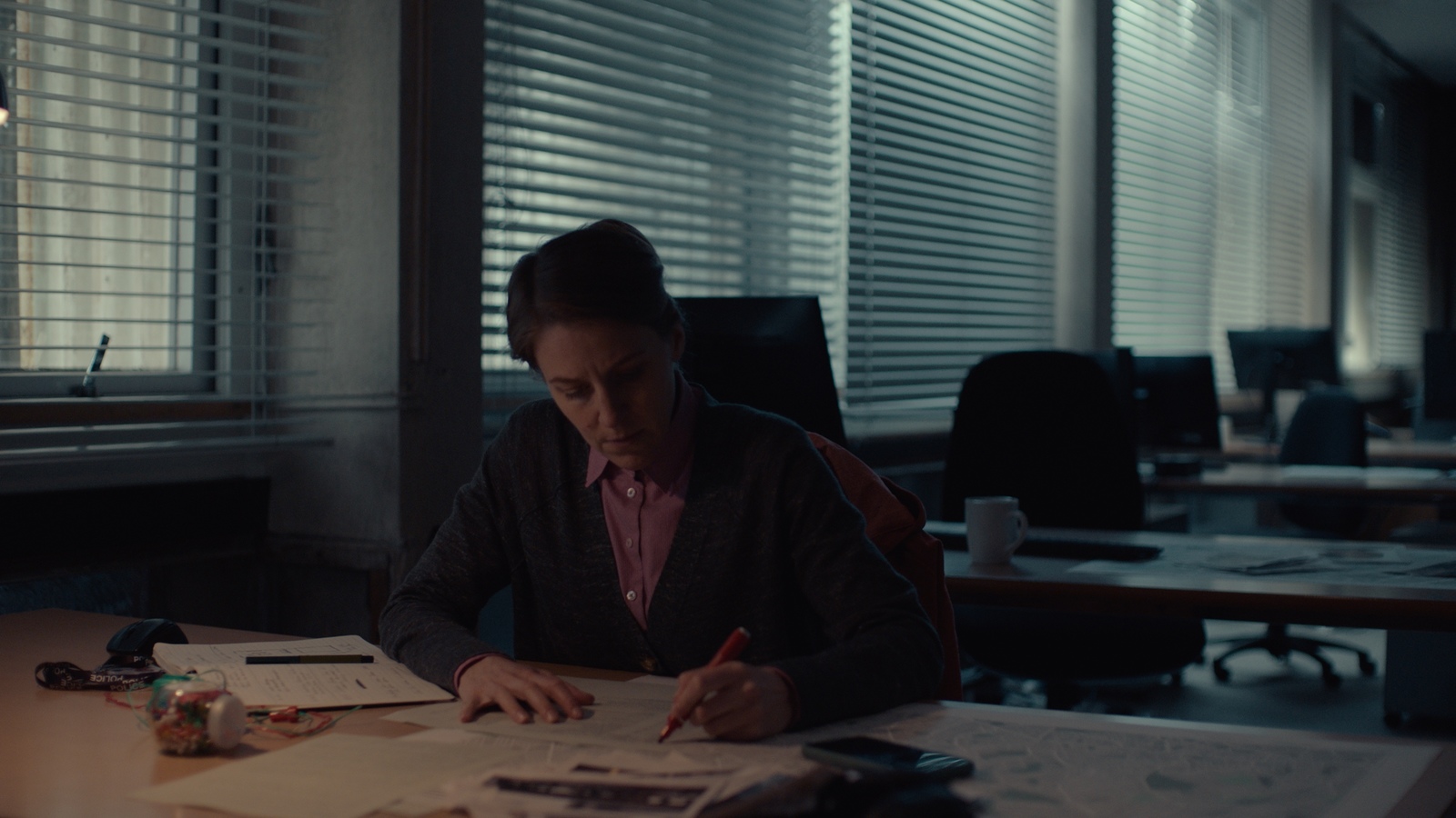 a woman sitting at a desk in an office