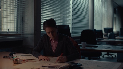 a woman sitting at a desk in an office