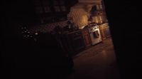 a dimly lit kitchen with a stove and oven