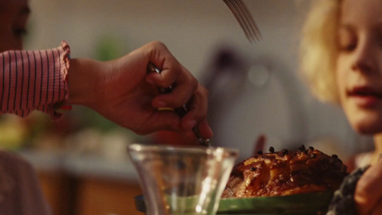 a woman is cutting a piece of meat on a plate