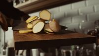 a person chopping up some food on a cutting board