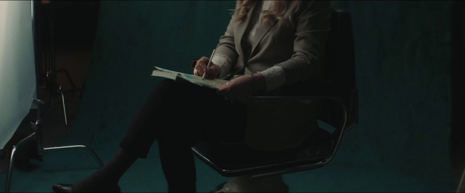 a woman sitting in a chair reading a book