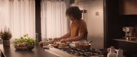 a woman is preparing food in a kitchen