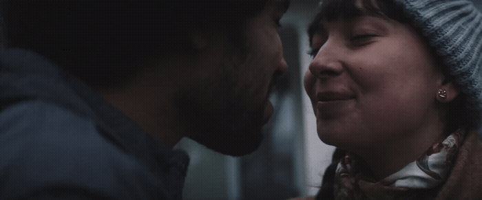 a man and a woman are looking at each other