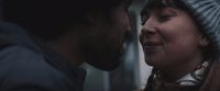 a man and a woman are looking at each other