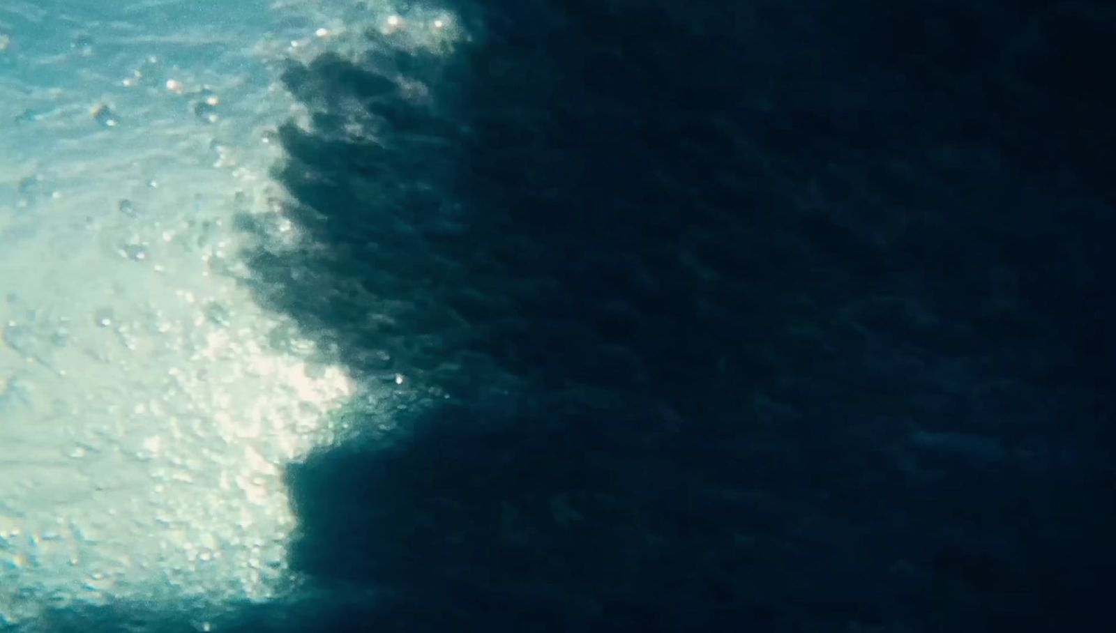 a person riding a surfboard on a wave in the ocean