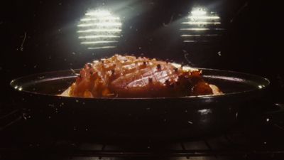 a roasting pan filled with food on top of a stove