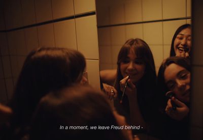 a group of women brushing their teeth in a bathroom