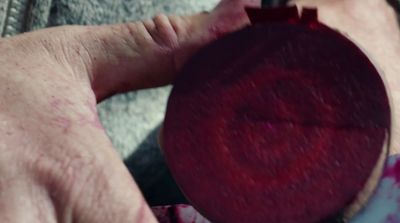 a close up of a person holding a red object