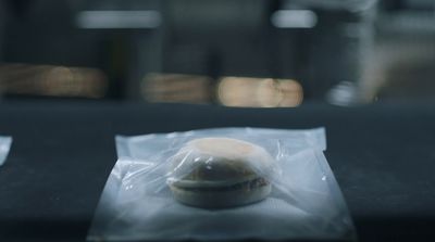 a donut wrapped in plastic sitting on top of a table