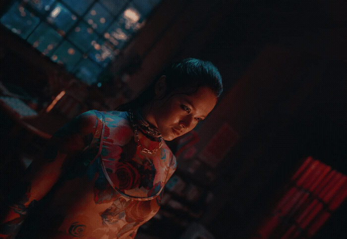 a woman with tattoos standing in a dark room