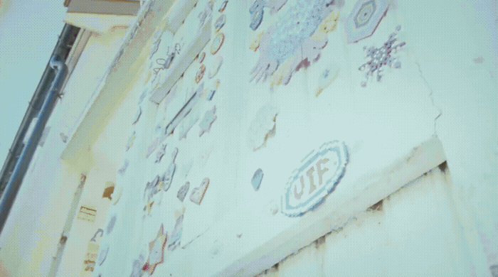 a wall with a lot of stickers on it