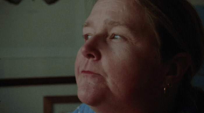 a woman with blue eyes looking off into the distance