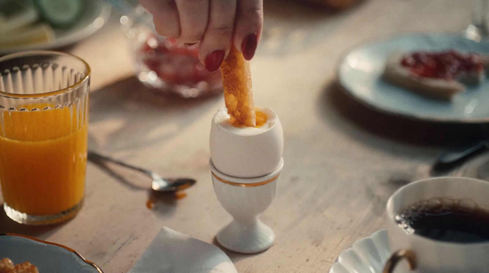 a person is holding a piece of food in front of a juicer