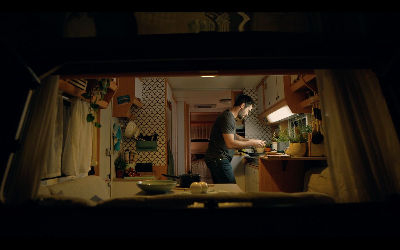 a man standing in a kitchen preparing food