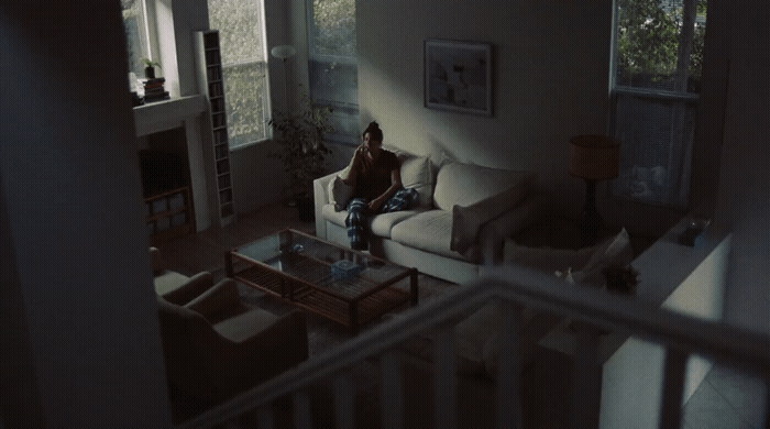 a person sitting on a couch in a living room