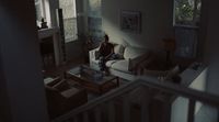 a person sitting on a couch in a living room