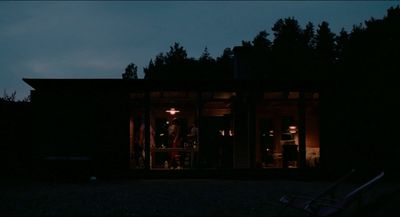 a group of people standing outside of a building at night