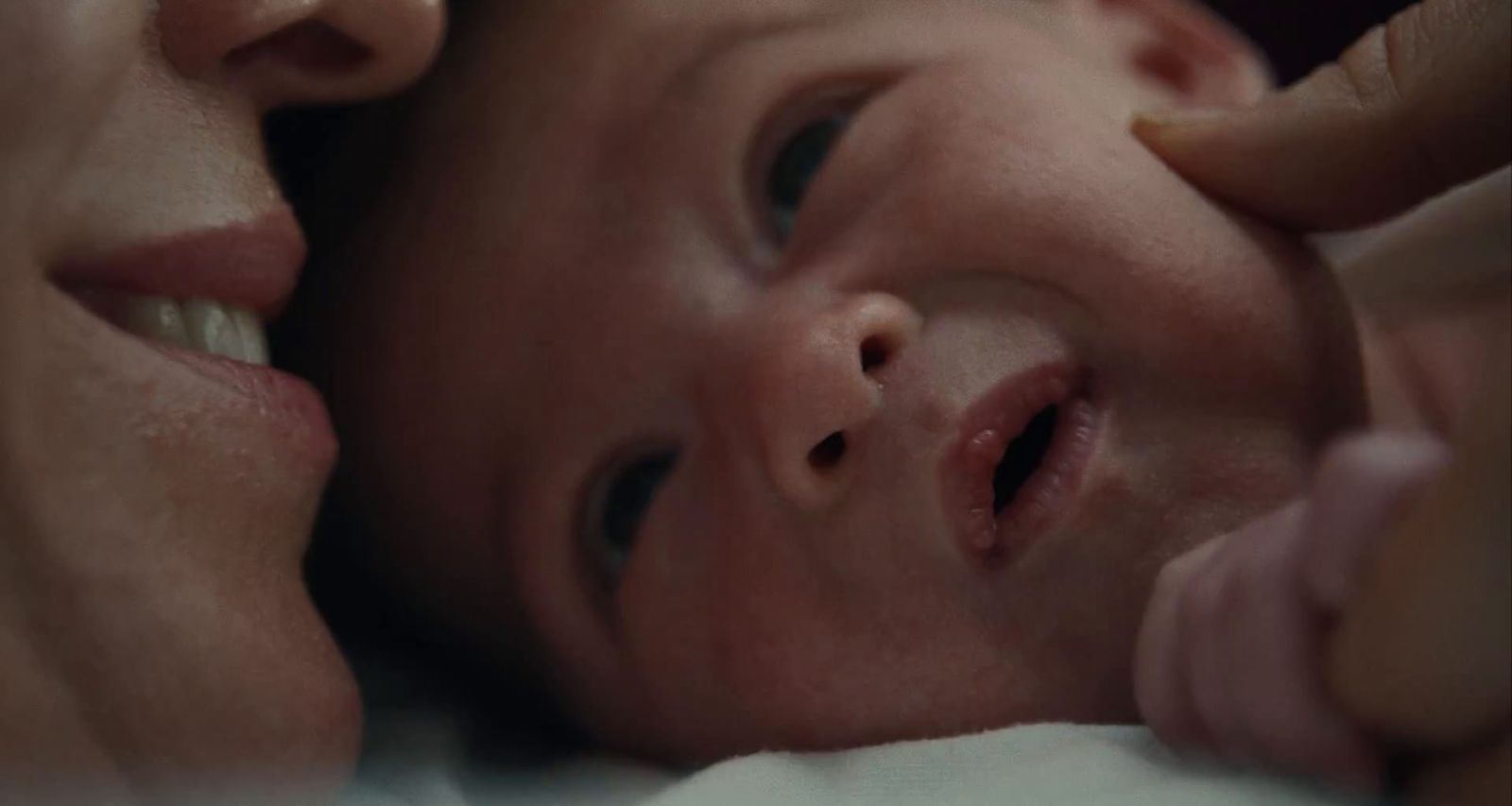 a close up of a person holding a baby