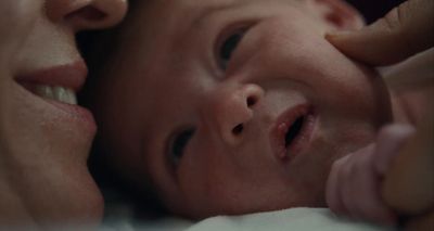 a close up of a person holding a baby