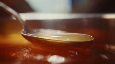 a spoon full of liquid sitting on top of a table