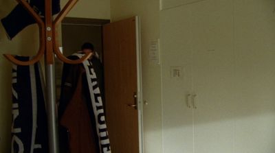 a room with a door and a coat rack