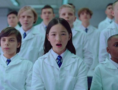 a group of young people in white lab coats