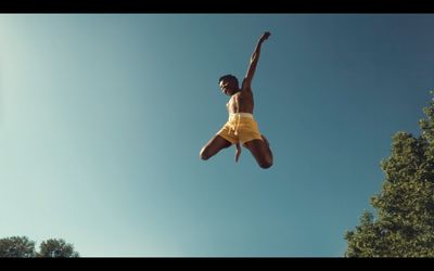 a man in yellow shorts jumping in the air