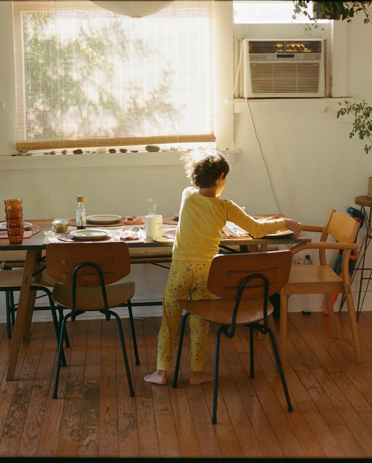 a little girl that is sitting at a table