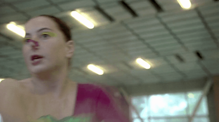 a woman in a pink top holding a white frisbee