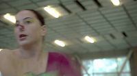 a woman in a pink top holding a white frisbee