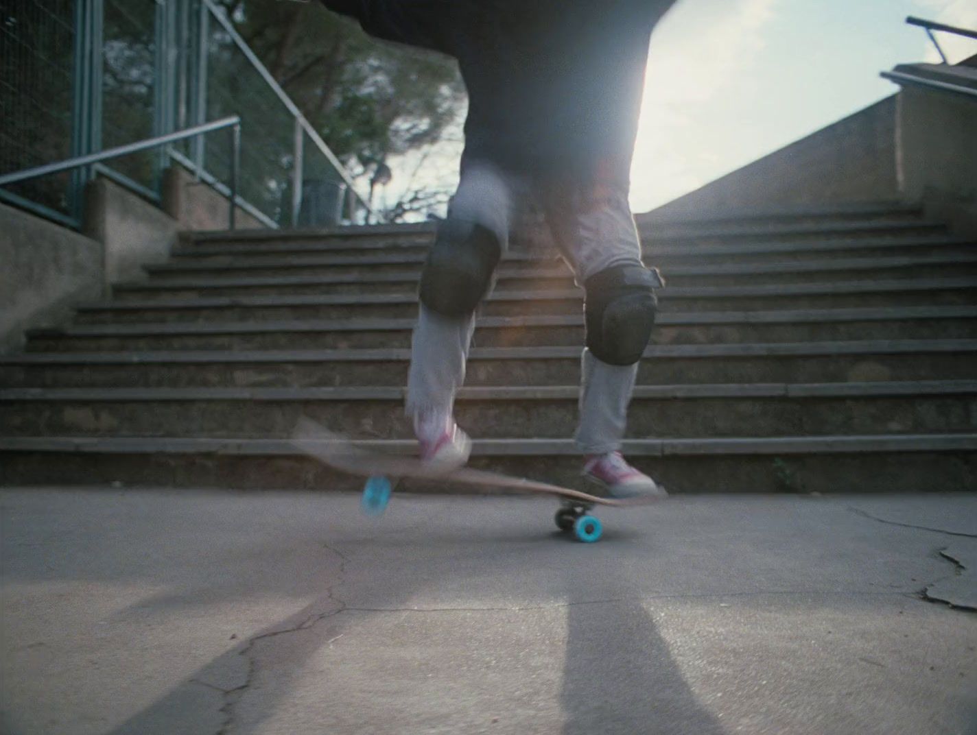 a person riding a skateboard down a flight of stairs