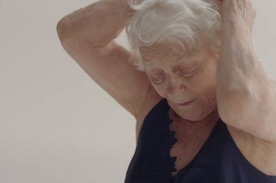 an older woman holding her head in her hands