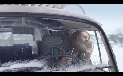 a man driving a car in the snow