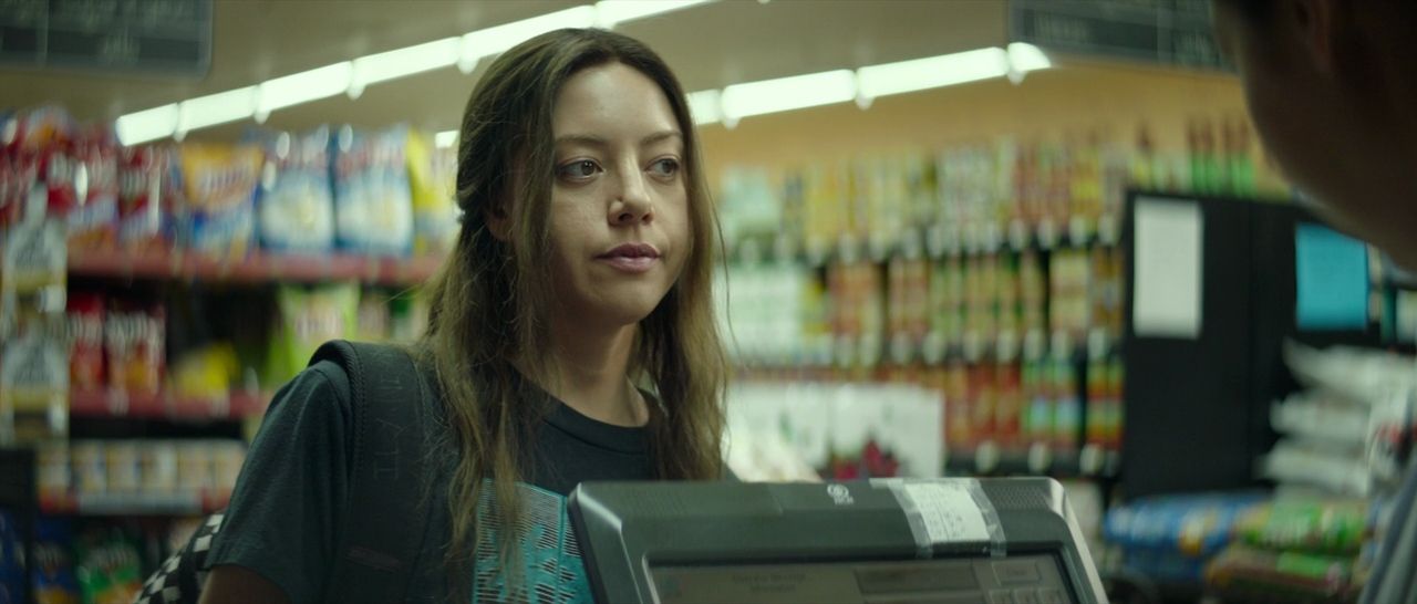 a woman standing in a store looking at a computer screen