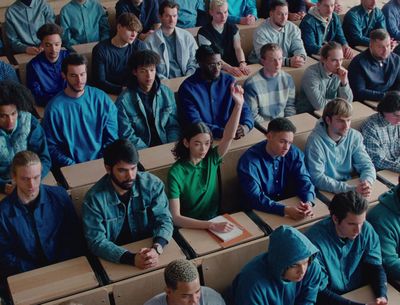 a large group of people sitting in a classroom