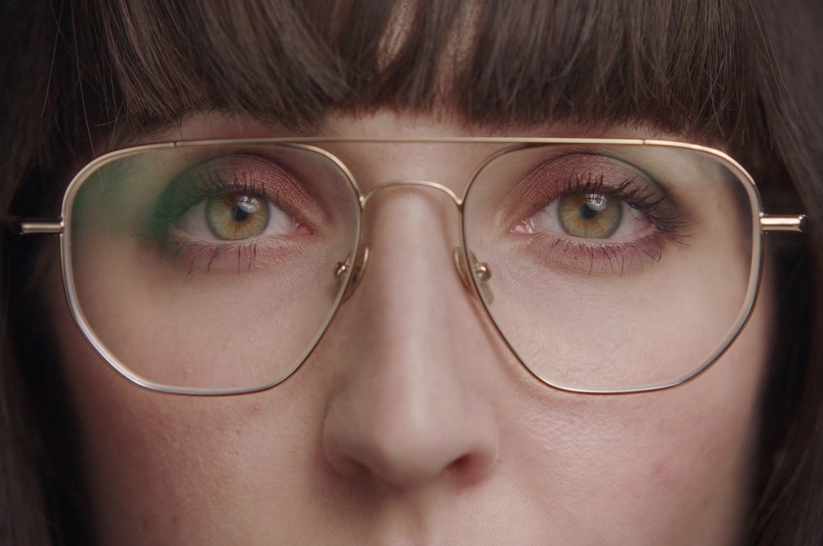 a close up of a person wearing glasses