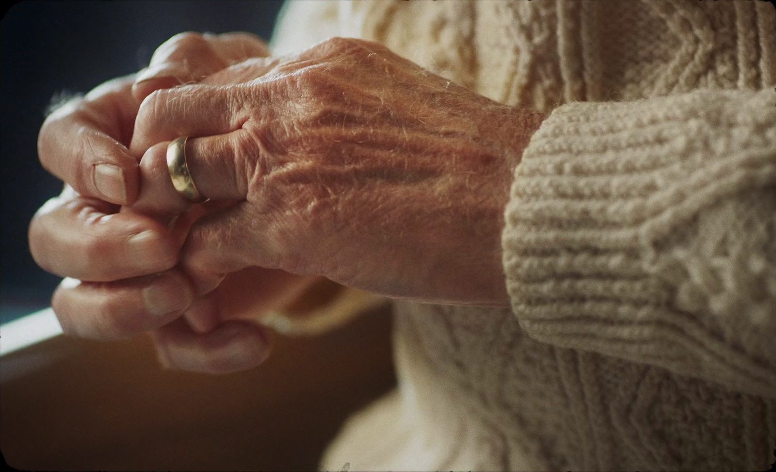 an older woman holding a younger woman's hand