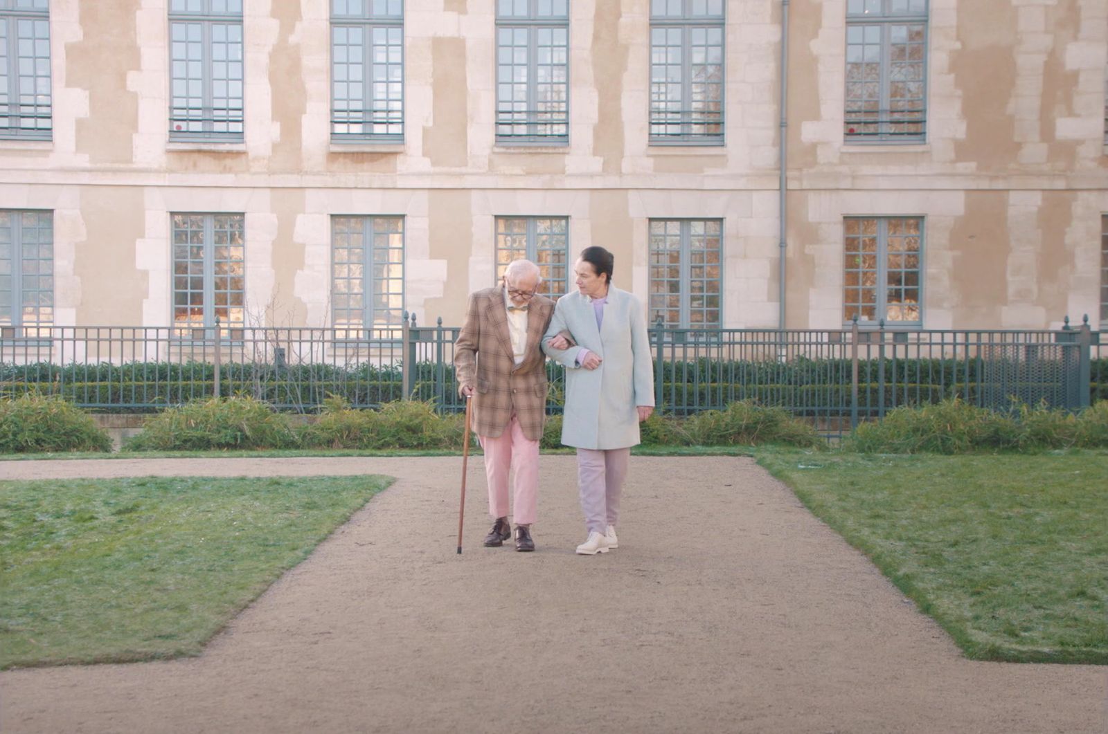 a couple of people that are standing in front of a building