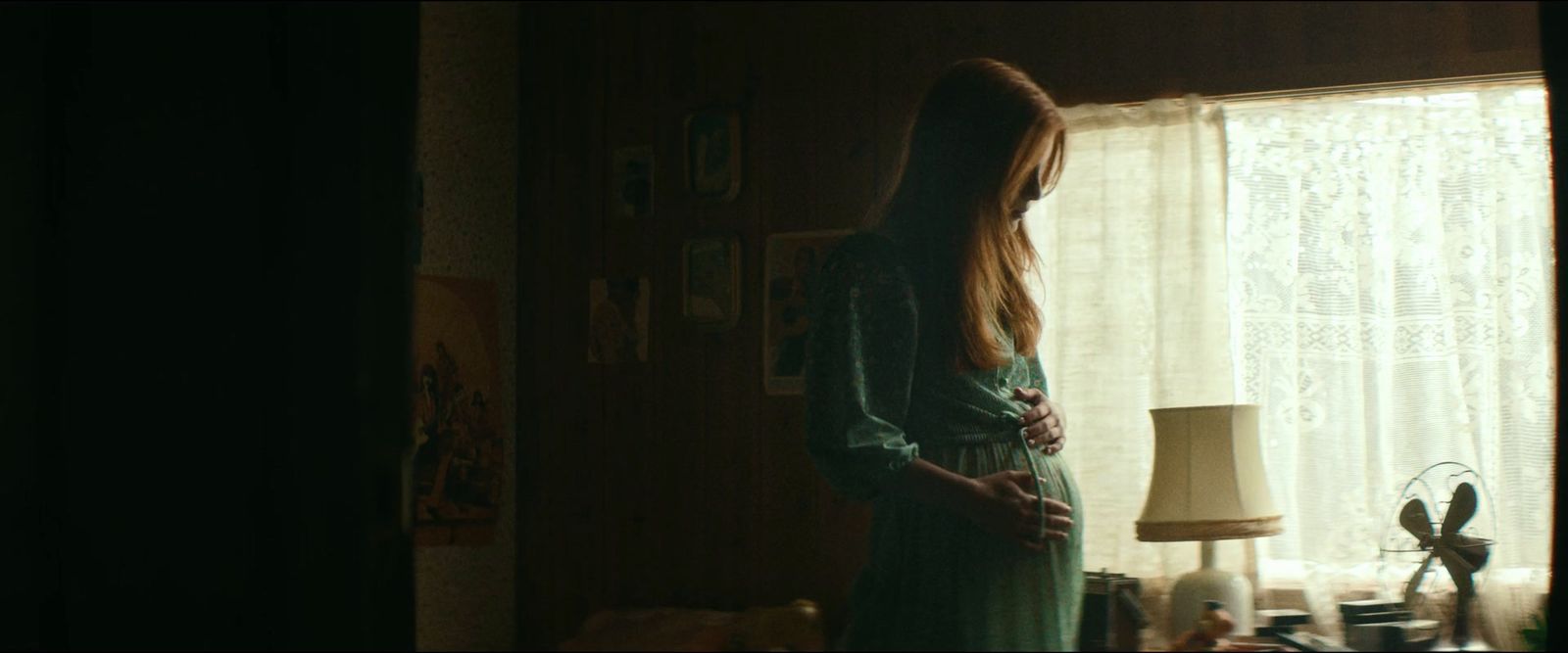 a woman standing in front of a window