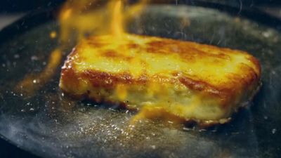 a piece of food cooking in a frying pan