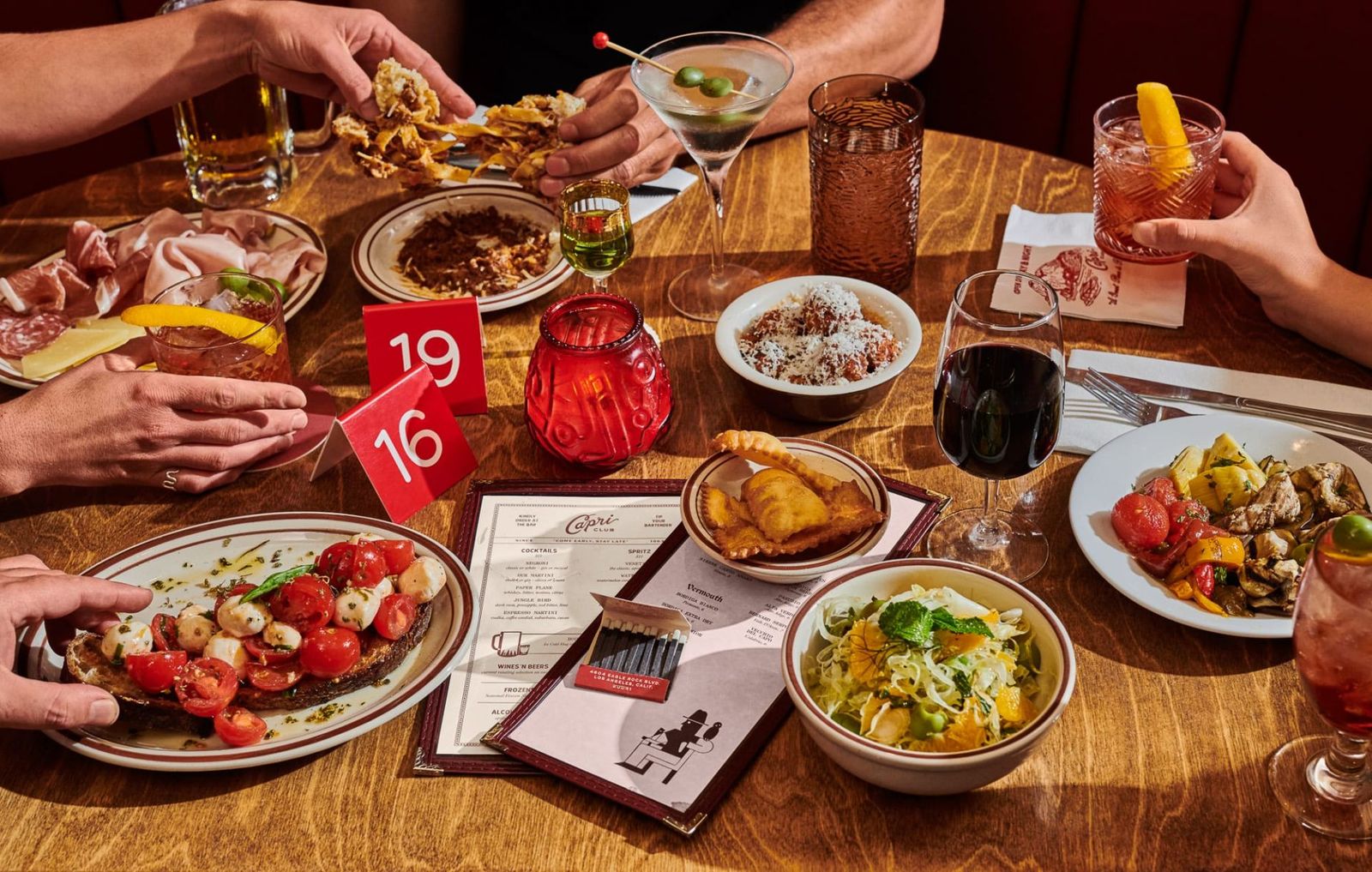 a group of people sitting around a table eating food